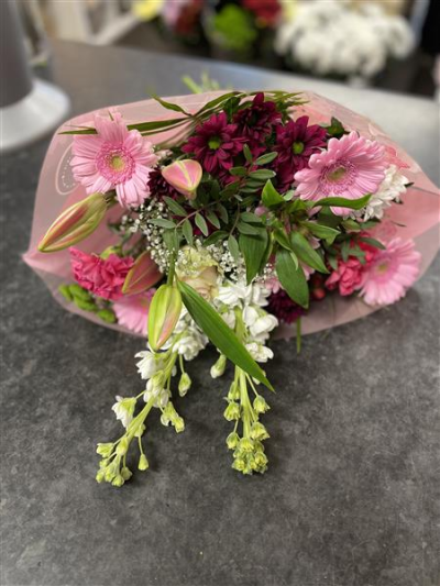 Pink Tied Bunch - A simple hand-tied bunch of pink and lilac blooms including gerberas, chrysanthemums, carnations and alstromeria.