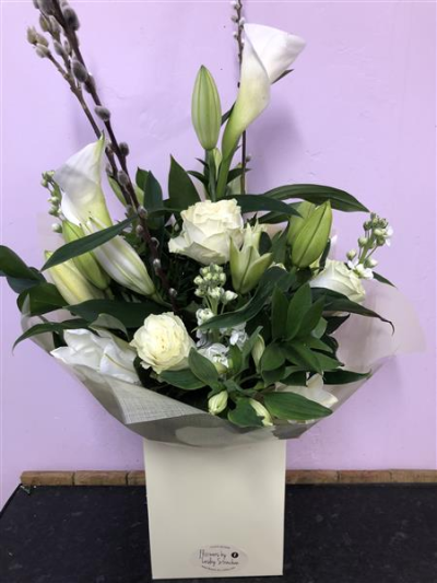 Pure & Simple - A handtied arrangement of white and cream blooms including roses, scented lilies and lisianthus.